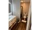 Bathroom featuring a modern vanity, toilet, and a glass-enclosed shower with tile surround at 2650 W State Road 252, Flat Rock, IN 47234