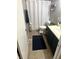 Bathroom featuring a sink with a dark vanity, toilet, shower curtain, and towel rack at 2650 W State Road 252, Flat Rock, IN 47234