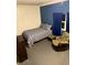 Cozy bedroom featuring a twin bed, a wood dresser and chair with blue walls and gray carpet at 2650 W State Road 252, Flat Rock, IN 47234