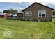 Exterior side view with a deck, garden, and barn in the background at 2650 W State Road 252, Flat Rock, IN 47234