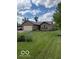 Charming brick home with attached garage and well-maintained front lawn and garden at 2650 W State Road 252, Flat Rock, IN 47234