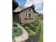 Close up of brick home with flower boxes under windows and manicured garden bed at 2650 W State Road 252, Flat Rock, IN 47234