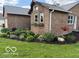 Brick home with flower boxes under windows and landscaped garden bed at 2650 W State Road 252, Flat Rock, IN 47234