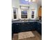 Bright kitchen with stainless sink, ample windows, and dark-colored cabinets at 2650 W State Road 252, Flat Rock, IN 47234