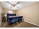 Bedroom with navy blue bed, ceiling fan, window with shade and neutral walls at 411 Red Tail Ln, Indianapolis, IN 46241
