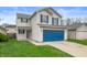 Charming two-story home with blue accents, attached two car garage and inviting curb appeal at 411 Red Tail Ln, Indianapolis, IN 46241