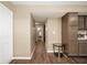 Hallway featuring wood-look flooring, neutral walls, and access to other rooms in the house at 411 Red Tail Ln, Indianapolis, IN 46241