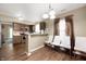 Open kitchen with brown cabinets, stainless appliances, and a bar-style counter with seating at 411 Red Tail Ln, Indianapolis, IN 46241