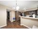 Spacious kitchen area with breakfast bar, adjacent to a dining area and additional living space at 411 Red Tail Ln, Indianapolis, IN 46241