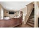Living room showcases a brown chaise lounge, staircase, and entrance to kitchen at 411 Red Tail Ln, Indianapolis, IN 46241