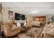 Living room showcases formal furniture and an entertainment center with fireplace at 411 Red Tail Ln, Indianapolis, IN 46241