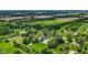 Picturesque aerial view of property with pool, surrounded by lush trees and farmland at 4131 N County Road 500 E, Danville, IN 46122