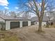 Spacious property featuring a white home with black trim and large garage with black doors at 4131 N County Road 500 E, Danville, IN 46122