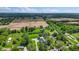 Expansive aerial view showcasing the property's setting amidst trees and agricultural land at 4131 N County Road 500 E, Danville, IN 46122