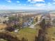 Aerial shot features a home with a backyard pool, set against the backdrop of the surrounding neighborhood at 4131 N County Road 500 E, Danville, IN 46122