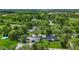 Expansive property featuring a black farmhouse, large metal outbuilding, and a sparkling above ground pool amidst lush greenery at 4131 N County Road 500 E, Danville, IN 46122