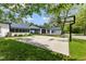 Large concrete sport court in backyard with basketball hoop, connects house and garage at 4131 N County Road 500 E, Danville, IN 46122
