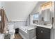 Well-lit attic bathroom with a soaking tub, modern sink, and ample storage, providing a serene and functional space at 4131 N County Road 500 E, Danville, IN 46122