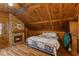 Charming bedroom featuring a stone fireplace and warm wood paneled walls and ceiling at 4131 N County Road 500 E, Danville, IN 46122