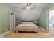 Bedroom in a finished attic, with sloped ceiling, and ceiling fan, alongside a connected bathroom offering ample natural light at 4131 N County Road 500 E, Danville, IN 46122