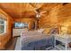 A bedroom features wood-paneled walls, a ceiling fan, and a TV atop a dresser, offering a cozy retreat at 4131 N County Road 500 E, Danville, IN 46122