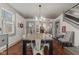 Spacious dining room featuring a large table, hardwood floors, and a staircase to the side at 4131 N County Road 500 E, Danville, IN 46122