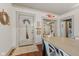 Welcoming entryway featuring hardwood floors, a decorative broom, and charming doorway to the rest of the home at 4131 N County Road 500 E, Danville, IN 46122