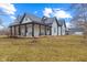 Charming exterior elevation of home featuring a metal roof and a cozy covered porch with seating at 4131 N County Road 500 E, Danville, IN 46122