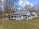 Stunning exterior elevation features a modern metal roof and a large concrete patio at 4131 N County Road 500 E, Danville, IN 46122