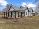 Charming exterior elevation of home featuring a metal roof and a cozy covered porch with seating at 4131 N County Road 500 E, Danville, IN 46122