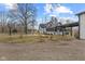 Charming exterior view featuring a lovely white home, a fire pit, and a basketball court at 4131 N County Road 500 E, Danville, IN 46122