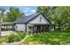 Attractive home with a black metal roof and a welcoming covered porch with rocking chairs at 4131 N County Road 500 E, Danville, IN 46122