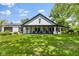 View of home with large covered porch featuring rocking chairs, and well-manicured lawn at 4131 N County Road 500 E, Danville, IN 46122