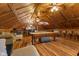 A game room includes a pool table, ceiling fans, wood-look floors, a lounge area, and a kitchenette at 4131 N County Road 500 E, Danville, IN 46122