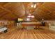 A rustic game room features wood-look floors, a pool table, a tv and a lounge area under a paneled ceiling with fans at 4131 N County Road 500 E, Danville, IN 46122