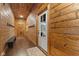 Hallway with wood paneled walls, hardwood floors, coat rack and a view of the outdoors at 4131 N County Road 500 E, Danville, IN 46122