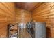 A laundry room features wood-paneled walls, modern front-load washer and dryer units, storage shelves, and wood-look flooring at 4131 N County Road 500 E, Danville, IN 46122