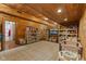 Spacious room with wood paneling, carpeted floors, and plenty of storage for toys at 4131 N County Road 500 E, Danville, IN 46122