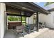 Outdoor patio area with hot tub and ample seating under a covered roof at 4131 N County Road 500 E, Danville, IN 46122
