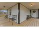 Inviting porch featuring wood flooring, black metal seating, a bench, and a lovely wreath on the front door at 4131 N County Road 500 E, Danville, IN 46122