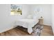 Bright bedroom featuring hardwood floors, white walls, two windows, a comfortable bed, and a stylish area rug at 453 Carol Dr, Greenwood, IN 46143