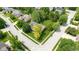 Aerial view of a corner lot featuring a brick home, mature trees, and a well-kept lawn in a residential neighborhood at 5208 Clear Lake Ct, Carmel, IN 46033