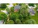 Aerial view of a well-maintained home with a spacious backyard, wooden deck, and mature trees in a residential area at 5208 Clear Lake Ct, Carmel, IN 46033