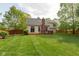 Well-maintained backyard features a spacious lawn, wooden deck, and privacy fence at 5208 Clear Lake Ct, Carmel, IN 46033