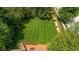 Aerial view of large backyard featuring a wooden deck, manicured lawn, and a wooden privacy fence at 5208 Clear Lake Ct, Carmel, IN 46033