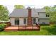 Backyard featuring a wooden deck, brick chimney, and a well-maintained lawn, perfect for outdoor enjoyment at 5208 Clear Lake Ct, Carmel, IN 46033