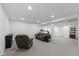 Open basement layout with carpeted floors, seating, and fitness equipment at 5208 Clear Lake Ct, Carmel, IN 46033