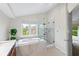 Luxurious bathroom featuring a soaking tub and a glass-enclosed shower at 5208 Clear Lake Ct, Carmel, IN 46033