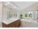 Bright bathroom featuring double vanity, soaking tub, and separate glass shower at 5208 Clear Lake Ct, Carmel, IN 46033