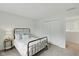 Cozy bedroom featuring a simple bed frame, closet and a side table with lamp at 5208 Clear Lake Ct, Carmel, IN 46033